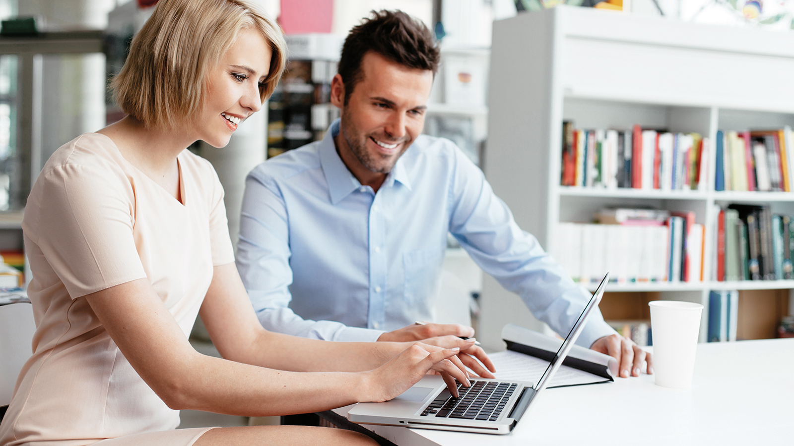 Businesspeople discussing while using digital tablet in office