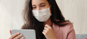 Woman with mask and mobile.png