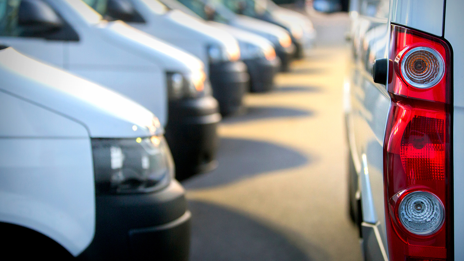 Commercial delivery vans in row at parking place