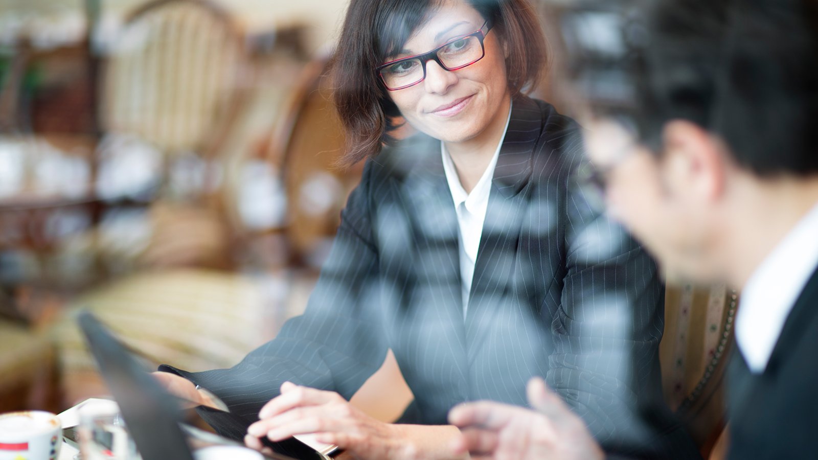 Business people discussing while using digital tablet in office