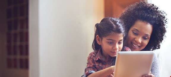 Shot of a mother and daughter using a digital tablet together at home