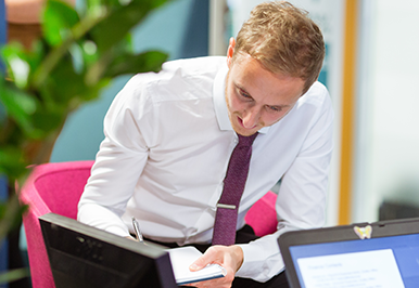 Man writing down important information in his business diary