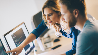 Man and woman working on a computer