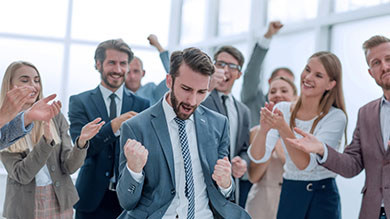 Group of cheerful business people celebrating their success